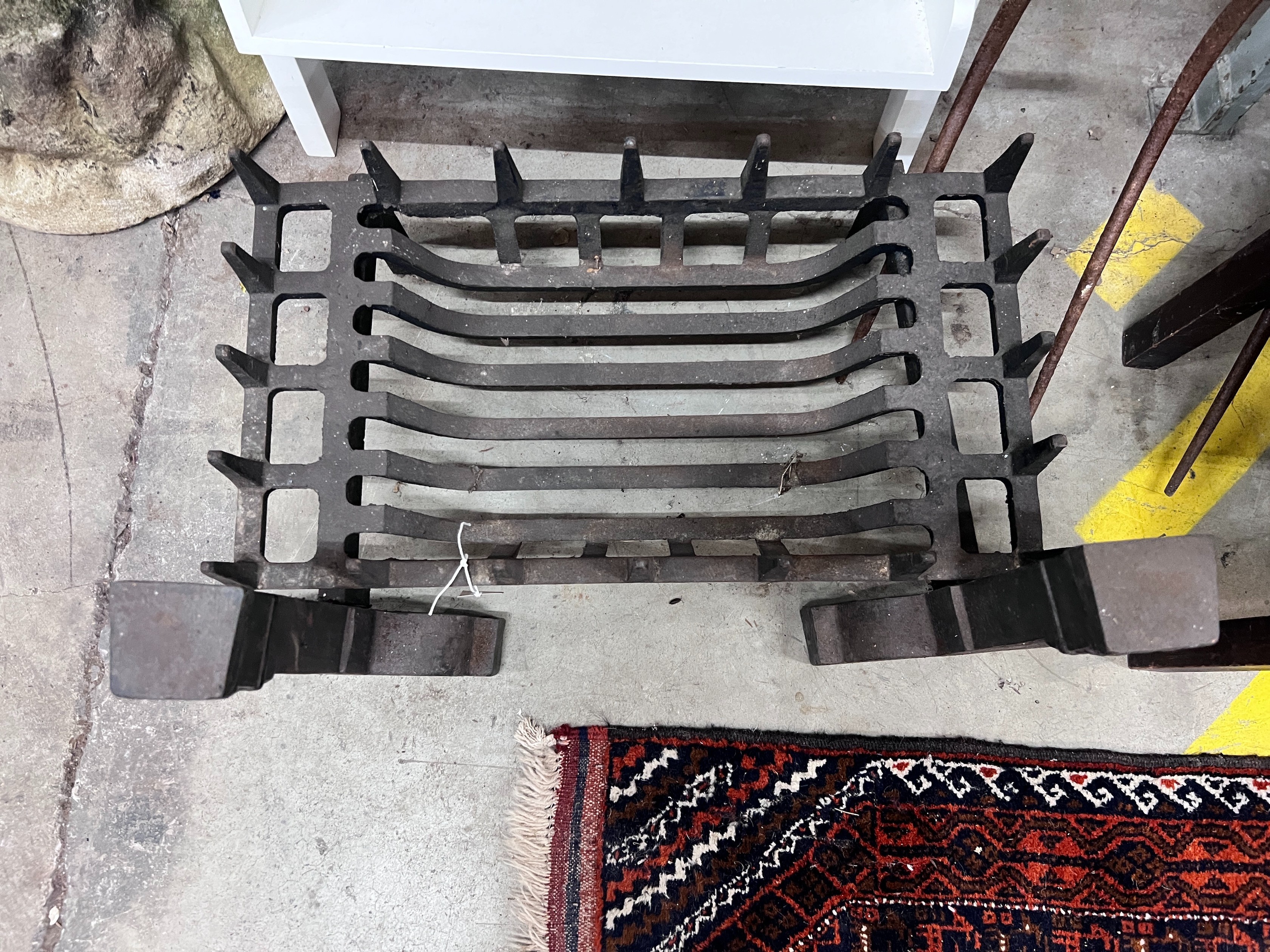 A cast iron fire grate, length 61cm, depth 33cm and a pair of fire dogs *Please note the sale commences at 9am.
